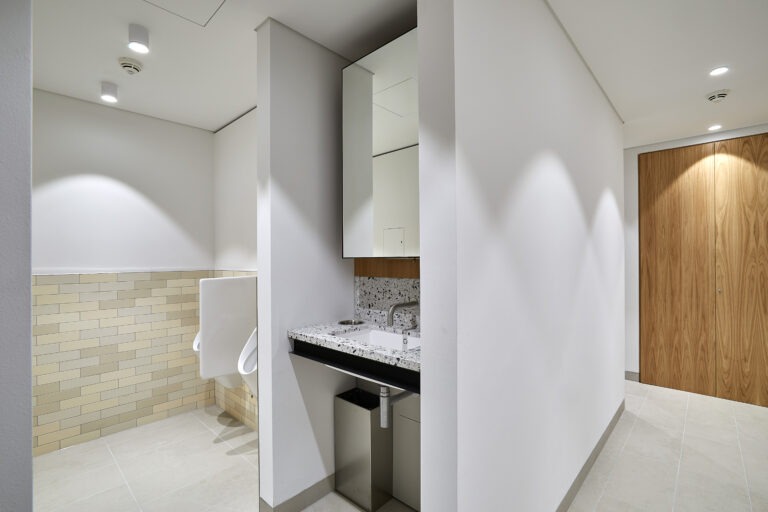 Image of Ceramic Urinal privacy screens and small Terrazzo vanity unit